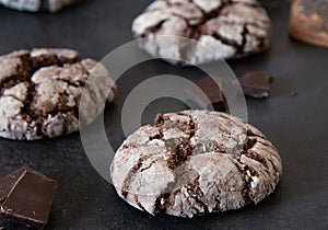 Chocolate Crinkles. Chocolate cookies in powdered sugar on a dark background