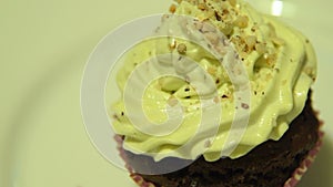 Chocolate cupcake with cream and nuts