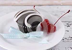 Chocolate cupcake with festive red maraschino cherries