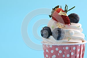 Chocolate cupcake isolated in blue background