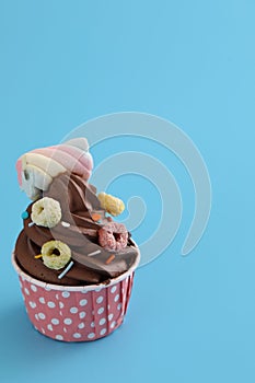 Chocolate cupcake isolated in blue background