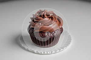 Chocolate Cupcake With Swirled Frosting on a White Table