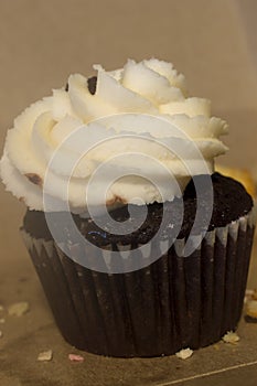 Chocolate cupcake topped with vanilla frosting