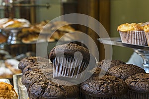 Chocolate cupcake in window of traditional sweet and pastry shop photo