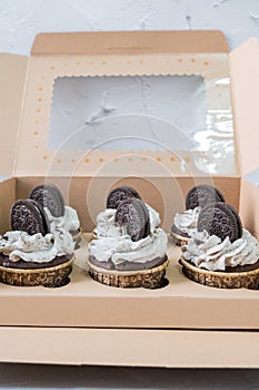 Chocolate cupcakes in brown cake boxes