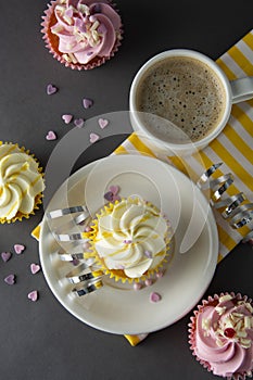 Chocolate cupcakes and coffee , breakfast with colorful cupcakes. Gray background. Sweet dessert