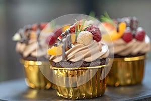 Chocolate cupcakes with fruits. A beautiful dessert.