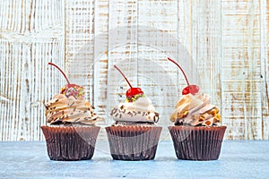 Chocolate Cupcakes on wood vintage background