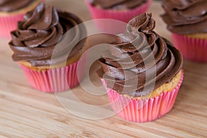Chocolate cupcakes on woodern board