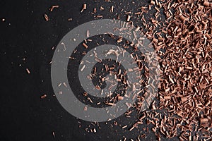 Chocolate curls and space for text on black background