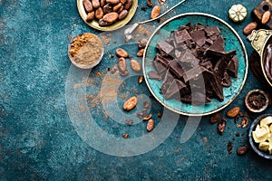 Chocolate. Dark bitter chocolate chunks, cacao butter, cocoa powder and cocoa beans. Chocolate background