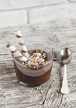 Chocolate dessert with cookies in glass beakers