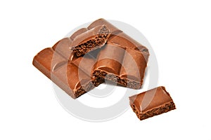 Chocolate dessert Pieces of porous chocolate are stacked on a white background