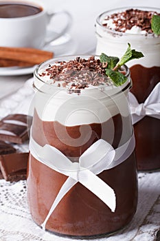 Chocolate dessert with whipped cream and coffee, vertical
