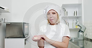 Chocolate desserts, chocolate drops, sweets. Close up portrait of young female confectioner, enjoying her work in pastry