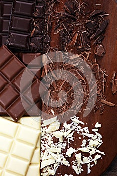 Chocolate in diffrent color. milk, dark and white chocolate bars on table