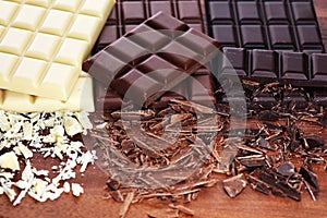 Chocolate in diffrent color. milk, dark and white chocolate bars on table