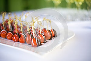 Chocolate dipped strawberries on a plate at a wedding table