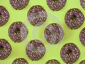 Chocolate donuts with almond pattern on green