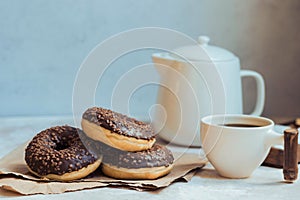 Chocolate donuts and coffee , weekend morning table breakfast. Vintage colors.