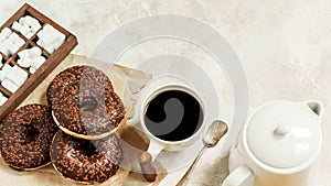 Chocolate donuts and coffee , weekend morning table breakfast. Vintage colors.