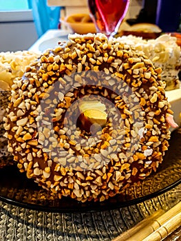 chocolate doughnut sprinkled with nut slices close up