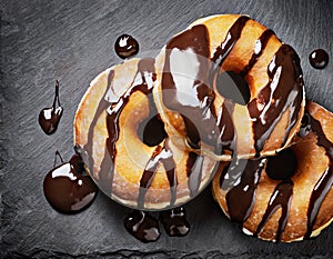 Chocolate doughnuts on black slate