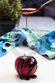 Chocolate drop on red apple fruit