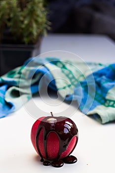 Chocolate drop on red apple fruit