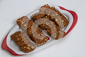Chocolate dry fruit biscuits in a plate on white background