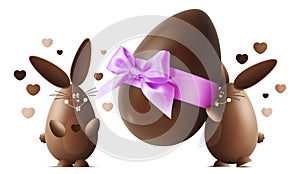 Chocolate Easter bunnies with egg and pink ribbon bow isolated o