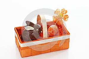 Chocolate easter bunny and egg in orange basket