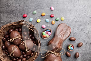 Chocolate Easter bunny and eggs on wooden background