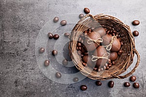 Chocolate Easter bunny and eggs on wooden background