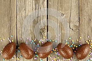Chocolate Easter egg border on wood