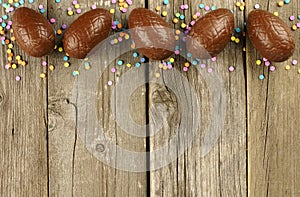 Chocolate Easter egg border on wood