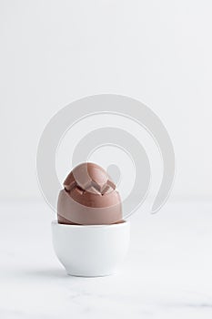 Chocolate easter egg in a white eggholder
