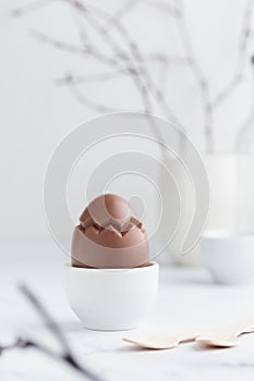 Chocolate easter egg in a white eggholder