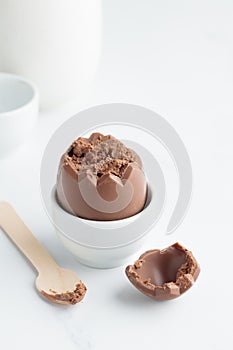 Chocolate easter egg in a white eggholder