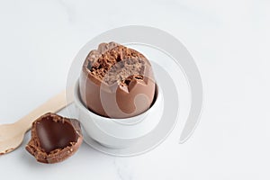 Chocolate easter egg in a white eggholder
