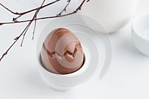 Chocolate easter egg in a white eggholder