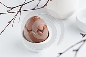 Chocolate easter egg in a white eggholder