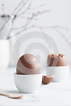 Chocolate easter egg in a white eggholder