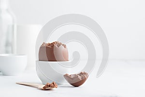 Chocolate easter egg in a white eggholder