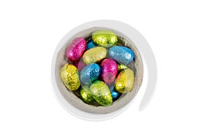 Chocolate Easter eggs in a basket isolated on white.