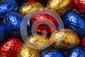 Chocolate easter eggs in colorful tinfoil close up full frame