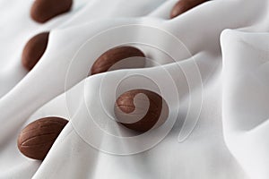 Chocolate Easter eggs in gauze fabric folds.
