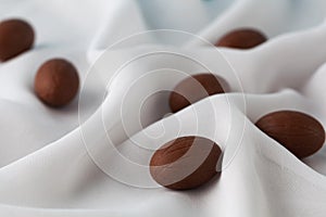 Chocolate Easter eggs in gauze fabric folds.