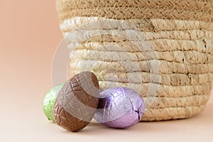 Chocolate Easter eggs next to a basket