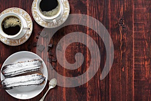 Chocolate eclairs on a wooden background